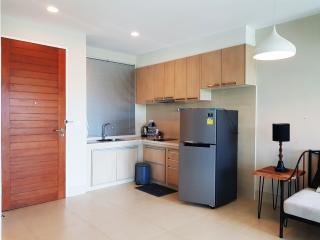 Modern kitchen with wooden cabinets and stainless steel appliances