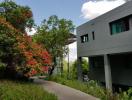 Modern house with lush garden and walking path