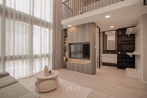 Modern living room with high ceiling and mezzanine