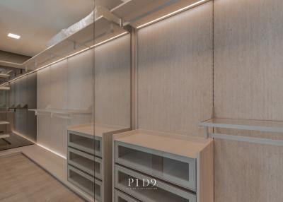 Modern walk-in closet with built-in lighting and shelving