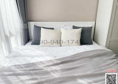 Cozy and neatly arranged bedroom with comfortable bedding and stylish pillows