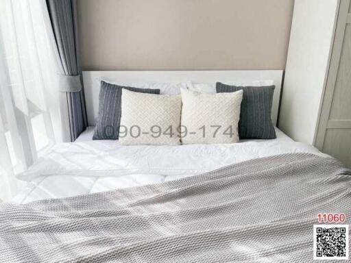 Cozy and neatly arranged bedroom with comfortable bedding and stylish pillows