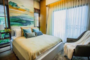 Cozy bedroom with large bed and artistic wall painting