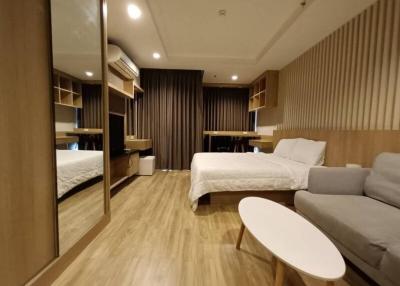 Modern bedroom with double bed and comfortable seating area