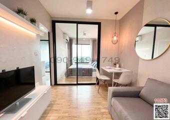 Modern living room with dining area and view into the bedroom