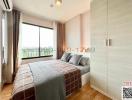 Bright bedroom with a large window and contemporary furnishings