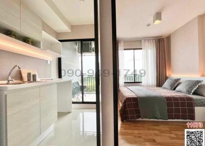 Modern bedroom with adjoining balcony and kitchenette