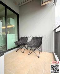 Compact balcony with two folding chairs and beige tiling