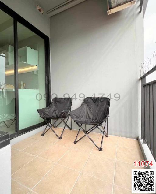 Compact balcony with seating arrangement and tiled flooring