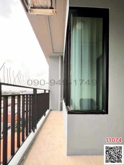 Spacious balcony with privacy wall and railing overlooking the surroundings