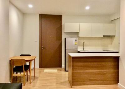 Modern kitchen with wooden finish and dining area