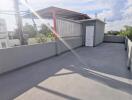 Spacious rooftop area with utility shed and open sky view