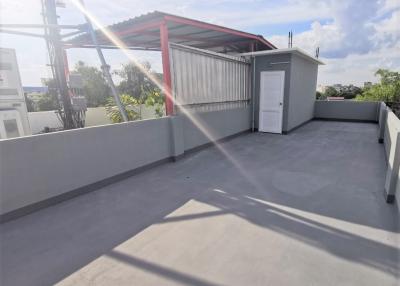 Spacious rooftop area with utility shed and open sky view