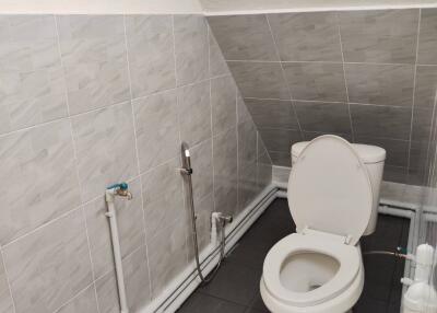 Small tiled bathroom with toilet
