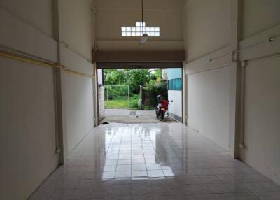 Spacious garage with a tiled floor and view of the outdoors