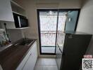 Modern kitchen interior with glass door and patterned curtain