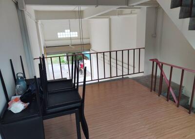 Upper-floor view with railing and stack of chairs