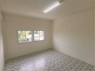 Bright bedroom with large window and tiled floor