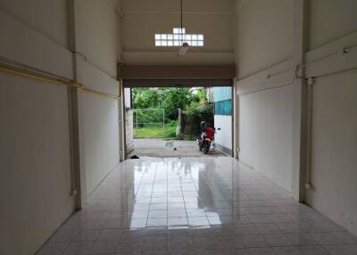 Empty garage with a motorcycle parked outside