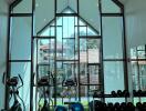 Modern home gym with large windows and cathedral ceiling