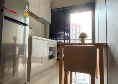 Modern kitchen with stainless steel appliances and natural light