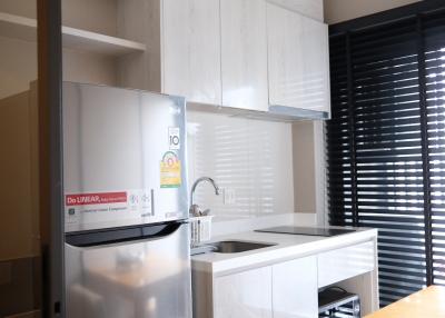 Modern kitchen with stainless steel appliances and white cabinetry