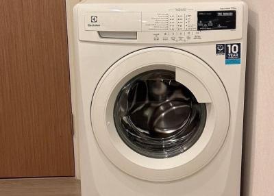 Front-loading Electrolux washing machine in a home laundry area