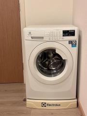 Front-loading Electrolux washing machine in a home laundry area