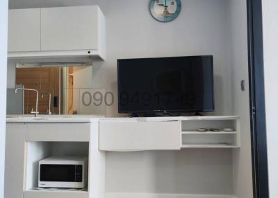 Modern living room interior with kitchenette and television