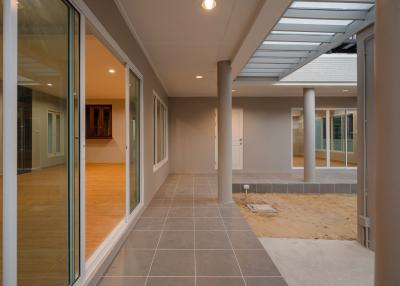 Spacious patio with tile flooring and partial roofing