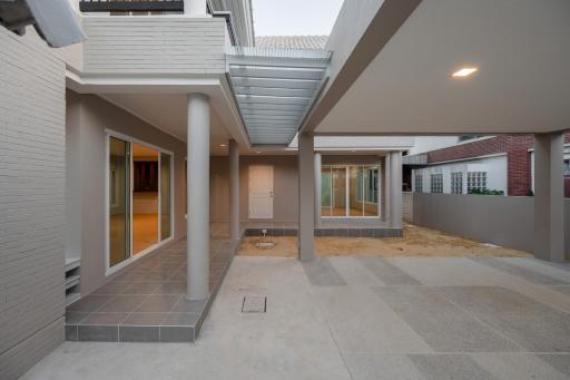 Spacious and modern home exterior with covered walkway