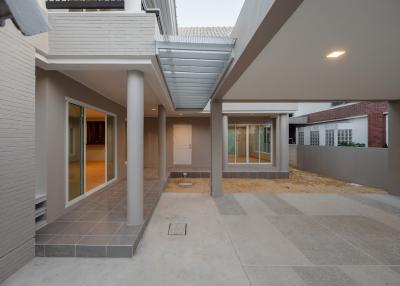Spacious and modern home exterior with covered walkway