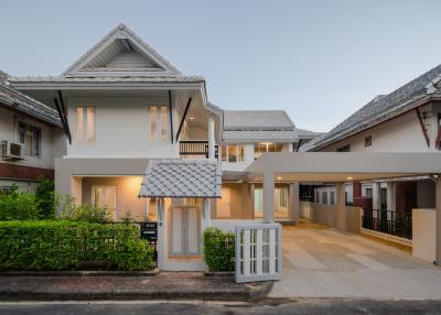 Modern two-story residential home exterior at dusk with driveway