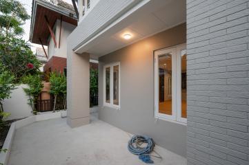 Cozy home patio with open sliding doors leading to interior