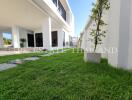 Modern building exterior with green lawn and spacious design