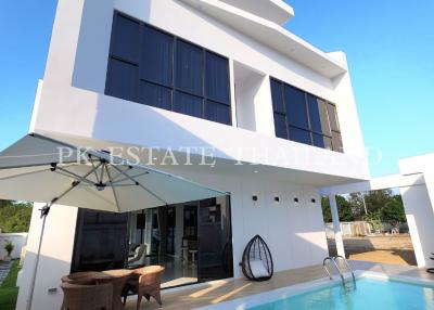 Modern two-story house with pool and outdoor seating