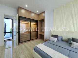 Spacious bedroom with a large bed, built-in wardrobes, and ample natural light