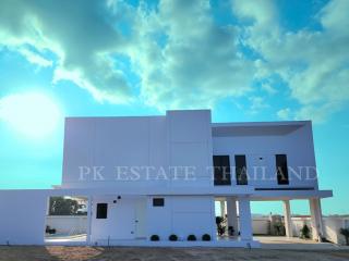 Modern white two-story house with blue sky