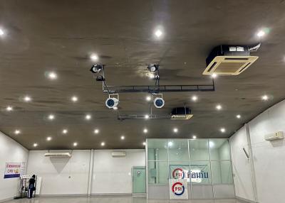 Modern interior of a large commercial space with reflective floors and ceiling installed spotlights