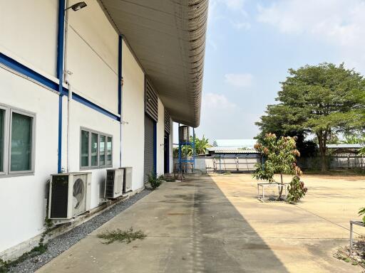 Exterior view of an industrial property with a wide driveway