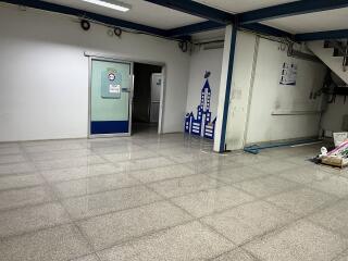 Spacious empty building interior with tiled flooring