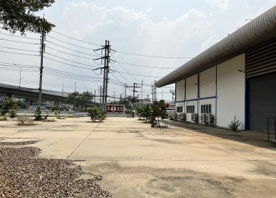 Spacious exterior of a commercial property with parking lot and utility poles