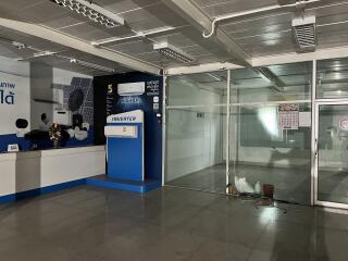 Empty commercial space with visible air conditioning unit advertisement