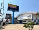 Commercial property exterior with a large billboard and blue sky