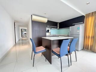 Modern kitchen with connected dining area and shiny tiled flooring