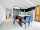 Modern kitchen with connected dining area and shiny tiled flooring