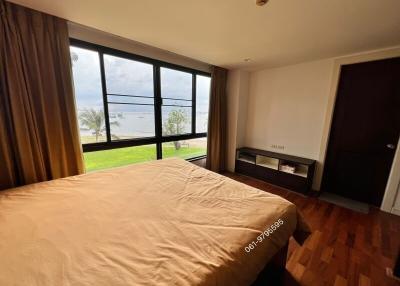 Spacious bedroom with large window and lake view