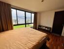 Spacious bedroom with large window and lake view