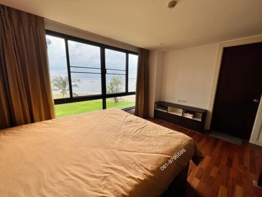 Spacious bedroom with large window and lake view