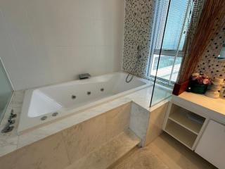 Modern bathroom with a large bathtub and glass shower